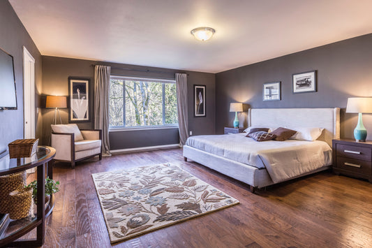 large modern bedroom with hardwood floors and chair